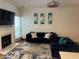 Inviting living room showcasing a fireplace, hardwood floors, and stylish blue sofas and throw pillows at 116 Madeline Ct, Mcdonough, GA 30253