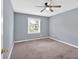 This bedroom features neutral walls, soft carpeting, and a ceiling fan at 122 Rue Fontaine, Lithonia, GA 30038