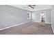 This bedroom features neutral walls, soft carpeting, and access to the bathroom at 122 Rue Fontaine, Lithonia, GA 30038