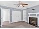Inviting bedroom featuring a fireplace, carpet, a ceiling fan, and ample closet space at 122 Rue Fontaine, Lithonia, GA 30038