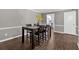 Open dining area featuring hardwood floors and a view into the kitchen at 122 Rue Fontaine, Lithonia, GA 30038