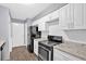 Efficient kitchen layout with white cabinets, granite countertops, and stainless steel appliances at 122 Rue Fontaine, Lithonia, GA 30038