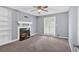 Comfortable living room with fireplace, built-in shelving, and french doors at 122 Rue Fontaine, Lithonia, GA 30038