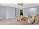 Spacious living room featuring neutral walls, carpet, and a view into the dining area at 122 Rue Fontaine, Lithonia, GA 30038