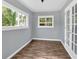 Bright sunroom with vinyl floors and light blue walls at 122 Rue Fontaine, Lithonia, GA 30038