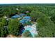 Aerial view of community pool and tennis courts surrounded by lush greenery at 2015 Towne Lake W Hls, Woodstock, GA 30189