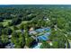 Expansive aerial view of the community tennis courts, pool, clubhouse, and verdant landscape at 2015 Towne Lake W Hls, Woodstock, GA 30189