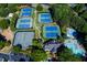 This aerial view showcases tennis courts and pool amenities for the community at 2015 Towne Lake W Hls, Woodstock, GA 30189