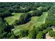 Beautiful aerial of lush golf course, walking bridge and a wooded area in the community at 2015 Towne Lake W Hls, Woodstock, GA 30189