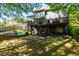 Expansive backyard featuring a multi-level deck with stairs and ample green space for outdoor activities at 2015 Towne Lake W Hls, Woodstock, GA 30189