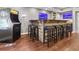 Basement wet bar features seating for six, wooden accents, and unique decor at 2015 Towne Lake W Hls, Woodstock, GA 30189