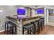 Basement wet bar features seating for six, wooden accents, and unique decor at 2015 Towne Lake W Hls, Woodstock, GA 30189