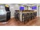 Basement bar with an arcade game, neon lighting, and seating for seven guests at 2015 Towne Lake W Hls, Woodstock, GA 30189