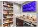 Stylish basement wet bar with a sink, shelving, and decorative Tennessee Vols decor at 2015 Towne Lake W Hls, Woodstock, GA 30189