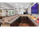 Basement wet bar features a long counter, under-cabinet storage, and unique decor at 2015 Towne Lake W Hls, Woodstock, GA 30189