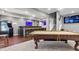 Finished basement with a pool table, bar area, arcade game, and entertainment space at 2015 Towne Lake W Hls, Woodstock, GA 30189