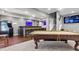 Finished basement boasts a pool table, wet bar, seating, and a large screen TV at 2015 Towne Lake W Hls, Woodstock, GA 30189