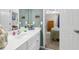 Bathroom with white sink vanity, neutral walls, and a view into the adjacent bedroom at 2015 Towne Lake W Hls, Woodstock, GA 30189