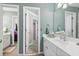 Bright bathroom featuring a double sink vanity, neutral paint, and access to other rooms at 2015 Towne Lake W Hls, Woodstock, GA 30189