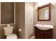 Cozy half bathroom featuring a wooden vanity and a framed mirror at 2015 Towne Lake W Hls, Woodstock, GA 30189