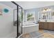 Bathroom featuring a corner soaking tub, a glass door shower, and double sink vanity at 2015 Towne Lake W Hls, Woodstock, GA 30189