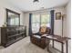 Bedroom with a mirror-topped dresser, leather recliner, and window view for comfortable living at 2015 Towne Lake W Hls, Woodstock, GA 30189
