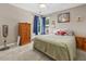 Cozy bedroom with carpeted floors, natural light and standard furniture at 2015 Towne Lake W Hls, Woodstock, GA 30189