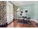 Comfortable room featuring a drum set, hardwood floors, and a large window at 2015 Towne Lake W Hls, Woodstock, GA 30189