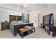 This bedroom features a tray ceiling, a large bed, and a flat screen television at 2015 Towne Lake W Hls, Woodstock, GA 30189