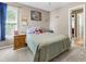 Cozy bedroom featuring carpet floors, a comfortable bed, and natural light from the window at 2015 Towne Lake W Hls, Woodstock, GA 30189