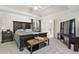 Bedroom with tray ceilings, a large tv, and a dark wood bed frame at 2015 Towne Lake W Hls, Woodstock, GA 30189