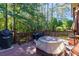 Spacious deck featuring a grill, covered furniture, and wooded views for memorable outdoor gatherings at 2015 Towne Lake W Hls, Woodstock, GA 30189