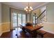Dining room with wood floors, dining table, and natural light from the window at 2015 Towne Lake W Hls, Woodstock, GA 30189