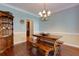 Dining room with wood floors, rustic table, and decorative chandelier at 2015 Towne Lake W Hls, Woodstock, GA 30189