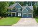 Attractive two-story home with a manicured lawn, stone accents and a spacious two-car garage at 2015 Towne Lake W Hls, Woodstock, GA 30189