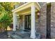 Exterior shot highlighting the stone-clad entrance with elegant double doors and stylish lighting fixtures at 2015 Towne Lake W Hls, Woodstock, GA 30189