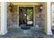 Inviting front entrance featuring stone facade, double doors, and elegant sconce lighting at 2015 Towne Lake W Hls, Woodstock, GA 30189