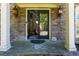 Inviting front entrance with stone facade, decorative lanterns, and glass front door at 2015 Towne Lake W Hls, Woodstock, GA 30189