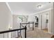 Upper hallway boasts natural light, carpet floors, and convenient access to the laundry room at 2015 Towne Lake W Hls, Woodstock, GA 30189