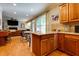 Bright kitchen featuring wood cabinets and breakfast bar open to living room at 2015 Towne Lake W Hls, Woodstock, GA 30189