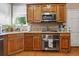 Kitchen featuring wooden cabinets, stainless steel oven, granite countertop at 2015 Towne Lake W Hls, Woodstock, GA 30189