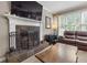 Comfortable living room featuring a fireplace, TV, plush seating, and carpeted floors at 2015 Towne Lake W Hls, Woodstock, GA 30189