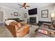 Cozy living room with fireplace, TV, and comfortable leather sofas at 2015 Towne Lake W Hls, Woodstock, GA 30189