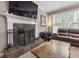 Inviting living room showcasing fireplace, mantel, and plush leather seating at 2015 Towne Lake W Hls, Woodstock, GA 30189