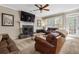 Living room featuring fireplace, mantel, and comfortable leather seating at 2015 Towne Lake W Hls, Woodstock, GA 30189