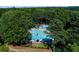 Aerial view of community pool with lounge chairs, umbrellas, tables, slide, and landscaped surroundings at 2015 Towne Lake W Hls, Woodstock, GA 30189