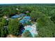 Aerial view showcases community tennis courts, pool and landscaped areas at 2015 Towne Lake W Hls, Woodstock, GA 30189