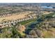 Picturesque aerial view of community with golf course and lake, providing beautiful scenery and recreational opportunities at 3313 Alhambra Cir, Hampton, GA 30228