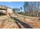 View of the backyard showing the home's back porch area and tree-lined lot at 3313 Alhambra Cir, Hampton, GA 30228
