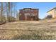 A large backyard featuring a brick home and plenty of room for activities and gatherings at 3313 Alhambra Cir, Hampton, GA 30228
